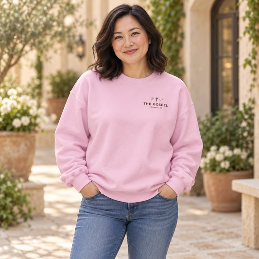 Model wearing the light pink Not Ashamed Romans 1:16 crewneck
